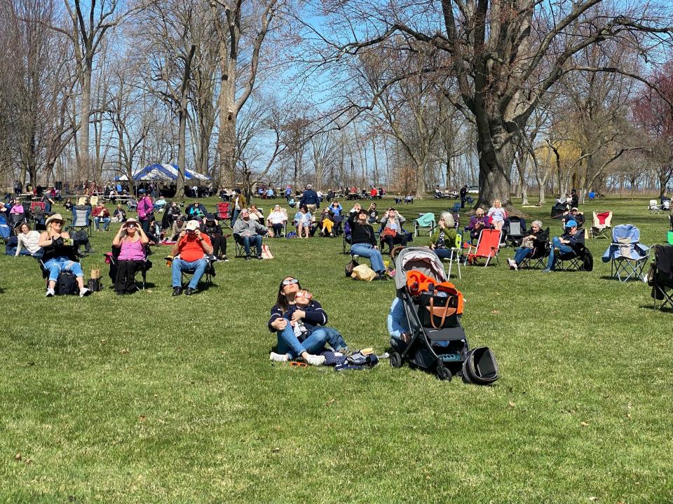 Michigan Science Center Astronomer announces the moon has made first contact with the sun and urges everyone to put on their glasses and look up on Monday, April, 4, 2024 at Ford House in Grosse Pointe Shores.