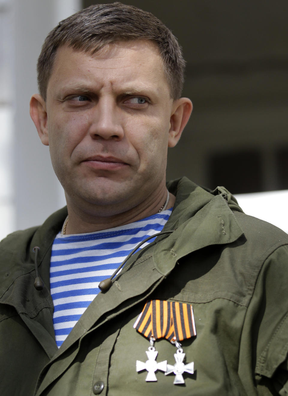 FILE - In this Wednesday, Oct. 1, 2014 file photo, Alexander Zakharchenko, the leader of pro-Russian rebels in Donetsk observes damage at a school after shelling in the town of Donetsk, eastern Ukraine. The leader of the Russia-backed separatists fighting in eastern Ukraine's Donetsk region was killed Friday, Aug. 31, 2018 by an explosion at a cafe, the separatists' news agency said Friday. Rebel news agency DAN said the afternoon explosion that killed Alexander Zakharchenko, 42, tore through the cafe in the region's principal city. (AP Photo/Darko Vojinovic, File)