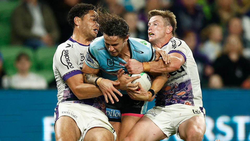 Seen here, Nicho Hynes being tackled against the Melbourne Storm in the NRL.