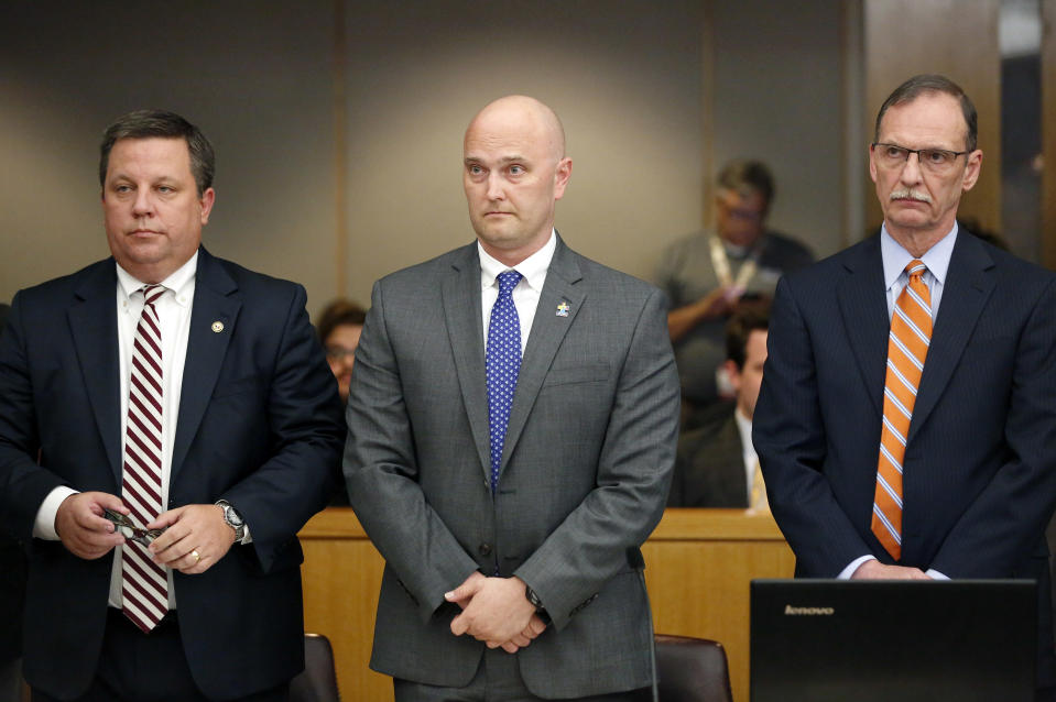 Fired Balch Springs police officer Roy Oliver, center, and his attorneys Miles Brissette, left, and Bob Gill stand before the reading of the verdict during Oliver's trial at the Frank Crowley Courts Building in Dallas on Tuesday, Aug. 28, 2018. Oliver was convicted of murder on Tuesday for fatally shooting an unarmed black teenager when he fired into a car full of teenagers leaving a house party in suburban Dallas. (Rose Baca/The Dallas Morning News via AP, Pool)