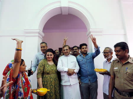 A woman (L) dances as she takes part in celebrations after learning the initial results inside the residence of Janata Dal (United) leader Sharad Yadav (C) in New Delhi, India, November 8, 2015. REUTERS/Anindito Mukherjee