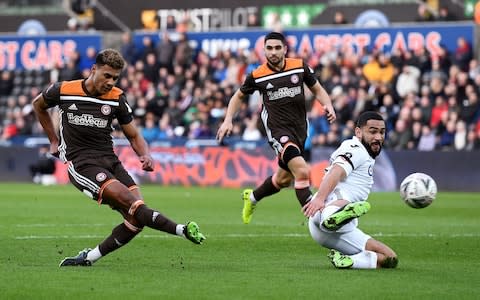 Ollie Watkins of Brentford scores his team's first goal during the FA Cup Fifth Round match between Swansea and Brentford  - Credit: Getty Images