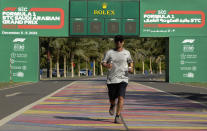 A man runs in front of a Formula One countdown clock on the corniche walkway in Jiddah, Saudi Arabia, Sunday, Nov. 21, 2021. The Formula One race takes place from Dec. 3-5 along the Red Sea city of Jiddah's coast, marking the first time the premier sporting event is held in Saudi Arabia. (AP Photo/Amr Nabil)