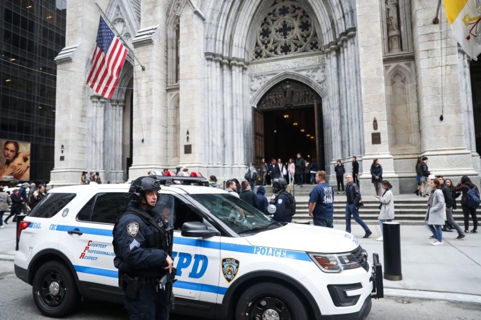 NYPD officers take security measures in front of the St. Patrick’s Cathedral the morning after a man was arrested after trying to enter the Cathedral with gas cans in 2019. Getty Images