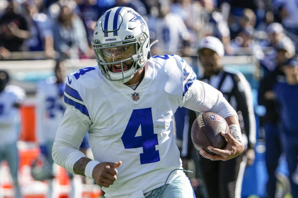 Dallas Cowboys quarterback Dak Prescott (4) rushes the ball during the first half of an NFL football game against the Jacksonville Jaguars, Sunday, Dec. 18, 2022, in Jacksonville, Fla. (AP Photo/John Raoux)