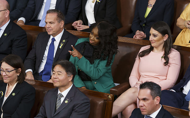 Rep. Jasmine Crockett (D-Texas) points as President Biden gives his State of the Union address during a joint session of Congress on Feb. 7. <em>Greg Nash</em>