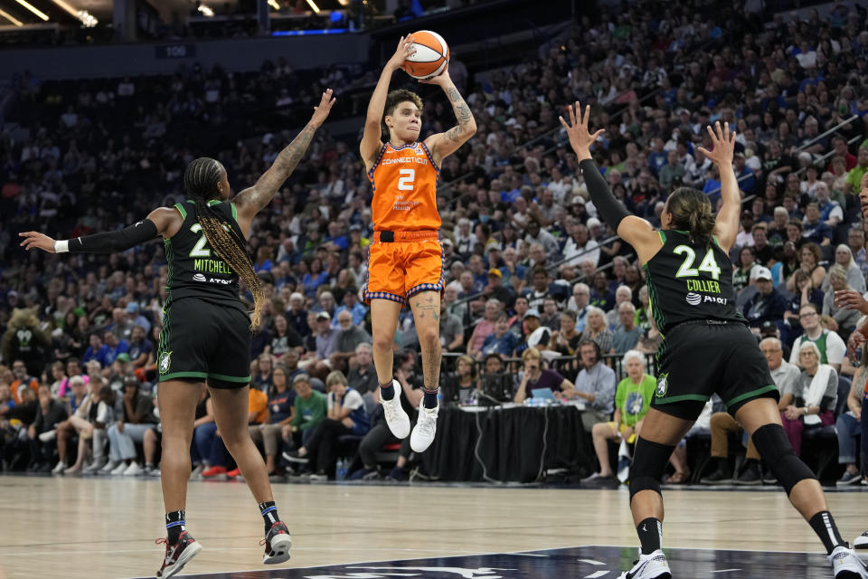 Connecticut Sun guard Natisha Hiedeman (2) shoots while defended by Minnesota Lynx guard Tiffany Mitchell, left, and forward Napheesa Collier (24) during the first half of Game 3 of a WNBA first-round basketball playoff series Wednesday, Sept. 20, 2023, in Minneapolis. (AP Photo/Abbie Parr)