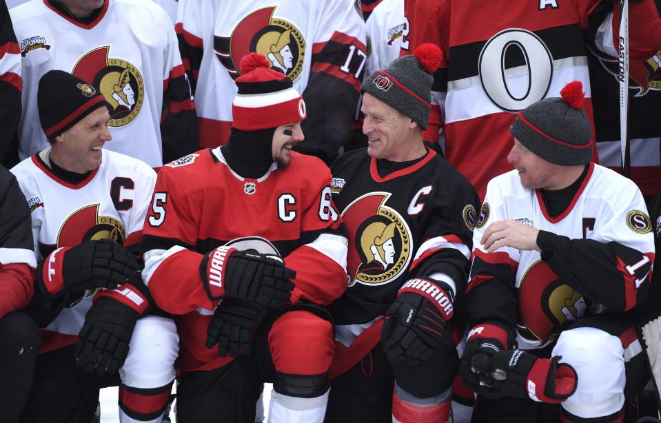 <p>Just a few captains past and present sharing a laugh. Erik Karlsson, Randy Cunneyworth, Daniel Alfredsson and Laurie Boschman relay some words of wisdom before posing for a group photo on Friday. </p>