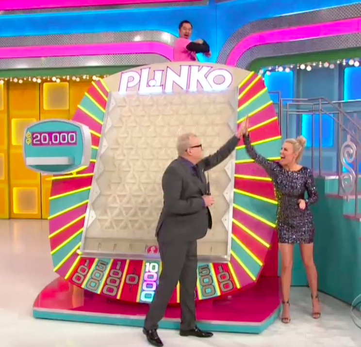 Drew Carey and Rachel Reynolds celebrate a contestant landing on $10,000 playing Plinko on “The Price Is Right.”