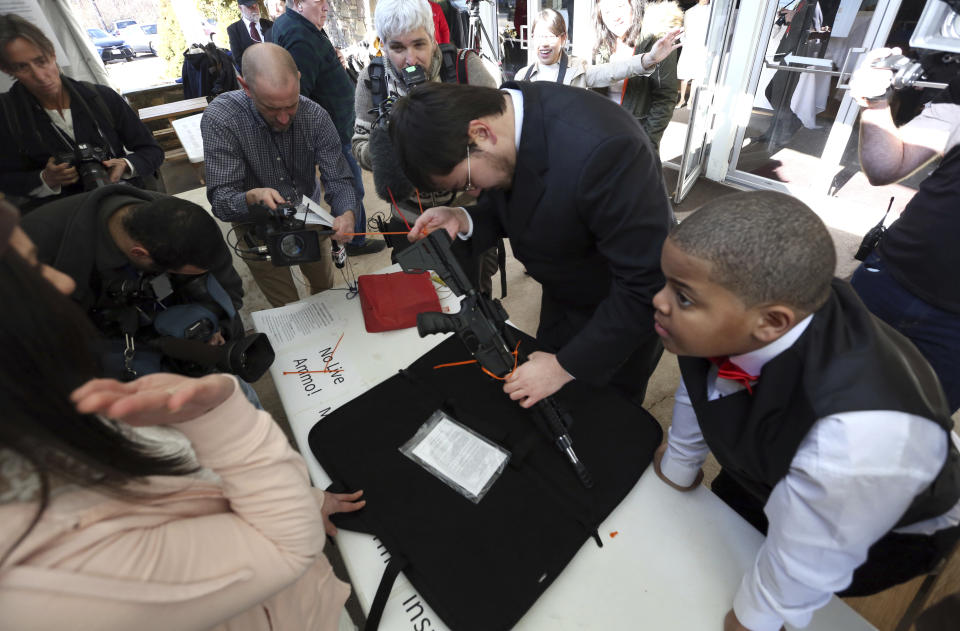 <p>A woman has her weapon checked for being unloaded and zip-tied at the World Peace and Unification Sanctuary, Wednesday Feb. 28, 2018 in Newfoundland, Pa. (Photo: Jacqueline Larma/AP) </p>