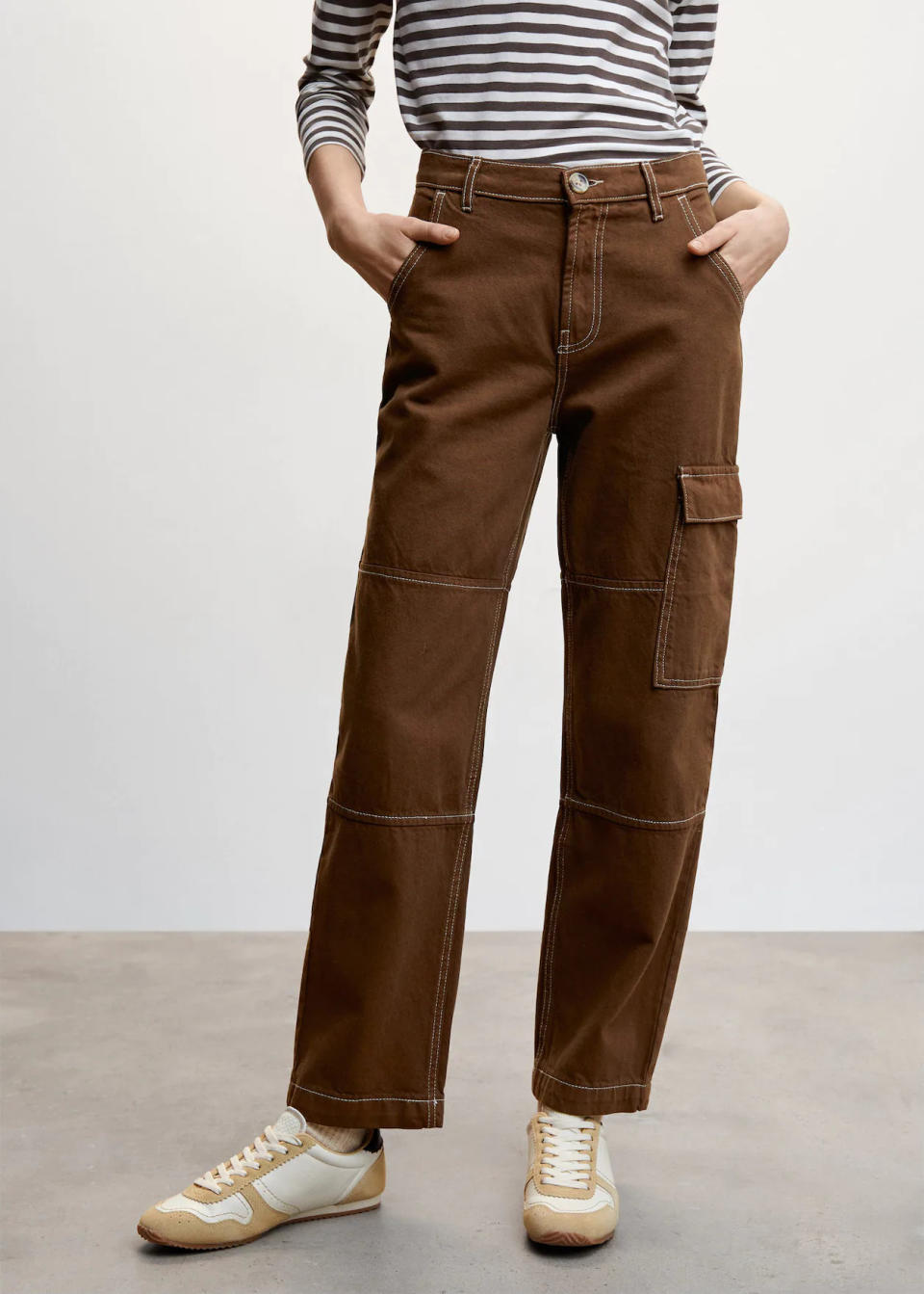 model wears brown Pocket Cargo Jeans. 
