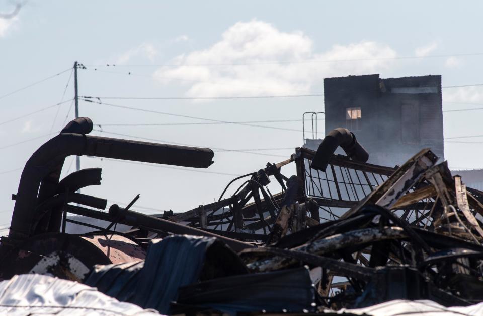 Debris from a fire that started Monday morning and destroyed the warehouse at 119 N. Morton Ave in Evansville, Ind., Tuesday morning, Oct. 18, 2022. The fire leveled a system of buildings that stretched across four parcels, hundreds of thousands of square feet, and had stood, in some capacity, for more than a century. No one was injured.