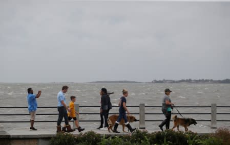 FILE PHOTO: People walk along the waterfront ahead of the arrival of Hurricane Dorian in Charleston