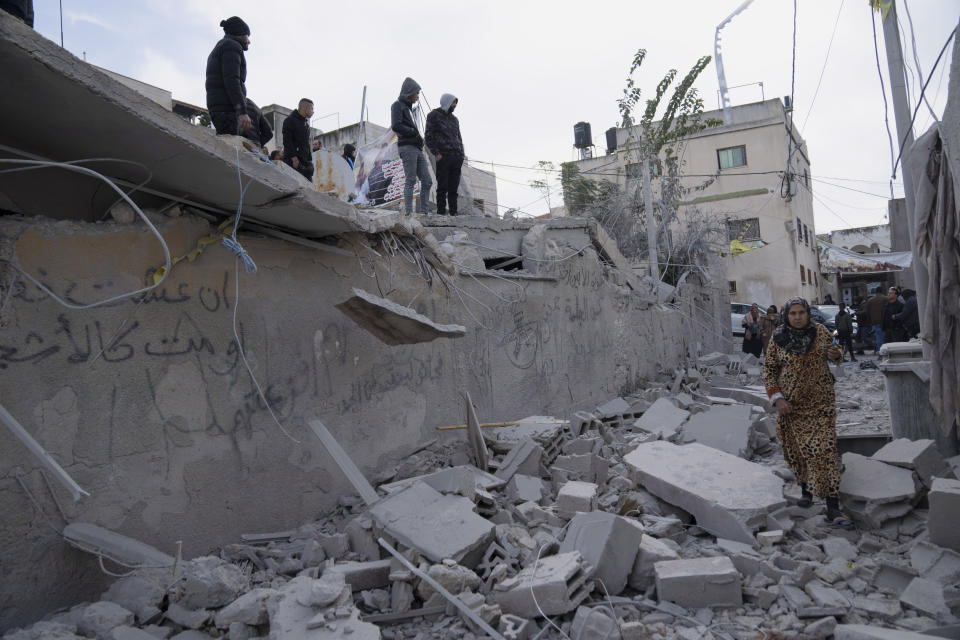 Palestinians inspect the site of a house that was demolished by the Israeli army in the West Bank village of Kafr Dan, near Jenin, Monday, Jan. 2, 2023. Palestinians Samer Houshiyeh and Fouad Abed were shot and killed during clashes with the Israeli army in the village of Kafr Dan near the northern city of Jenin. The Israeli military said it entered Kafr Dan late Sunday to demolish the houses of two Palestinian gunmen who killed an Israeli soldier during a firefight in September. The military said troops came under heavy fire and fired back at the shooters. (AP Photo/Nasser Nasser)