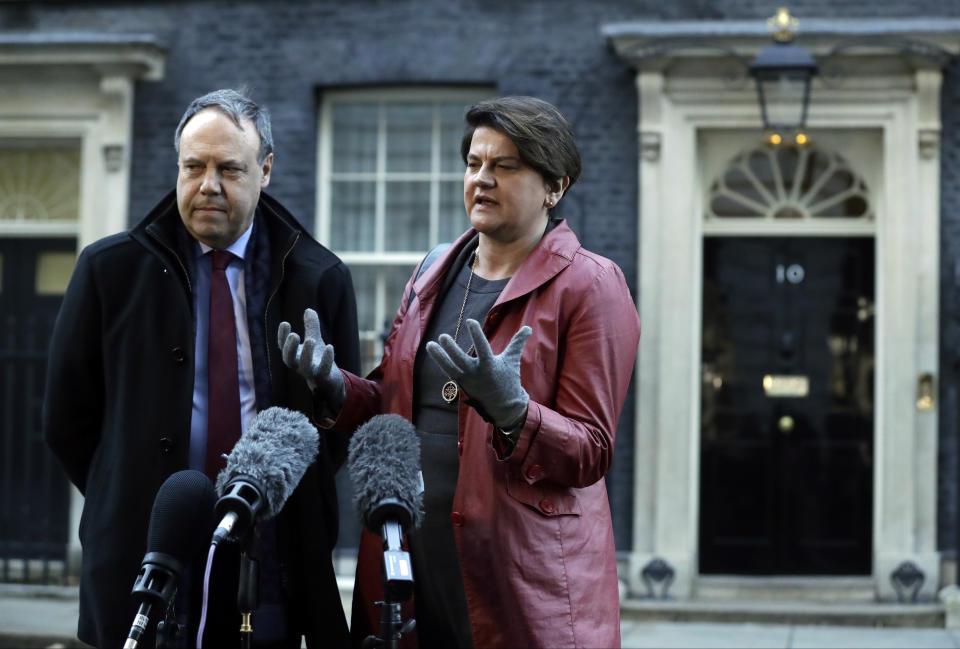 DUP Party leader Arlene Foster and Deputy Leader Nigel Dodds, left, make a statement to the media after exiting 10 Downing Street. London, Thursday Jan. 17, 2019. British Prime Minister Theresa May is reaching out to opposition parties and other lawmakers Thursday in a battle to put Brexit back on track after surviving a no-confidence vote. (AP Photo/Matt Dunham)