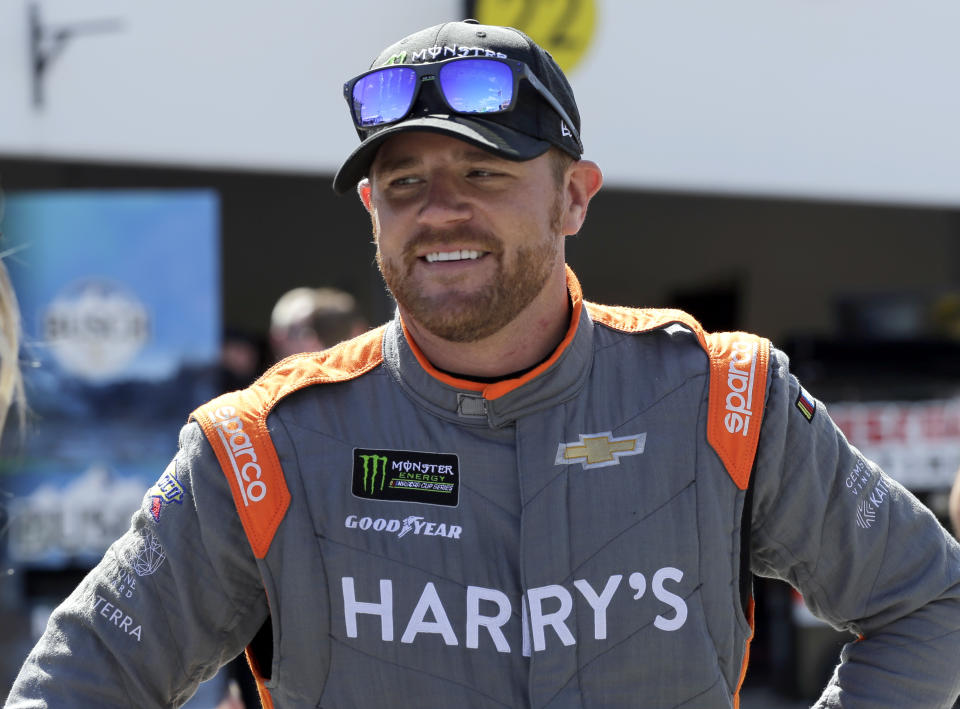 FILE v - In this Saturday, Feb. 17, 2018, file photo, Justin Marks walks through the garage during practice for the NASCAR Daytona 500 Cup Series auto race at Daytona International Speedway in Daytona Beach, Fla. Former driver Justin Marks has started a new NASCAR team that will field a car in 2021 for Daniel Suarez. The team announced Wednesday will be called Trackhouse Racing and field the No. 99 Chevrolet for Suarez. (AP Photo/Terry Renna, File)