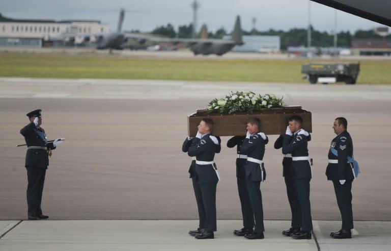 The coffin of Ann McQuire, who was killed in an attack in Port El Kantaoui, Tunisia, is taken from the RAF C-17 plane at RAF Brize Norton in Oxfordshire, England, on July 2, 2015