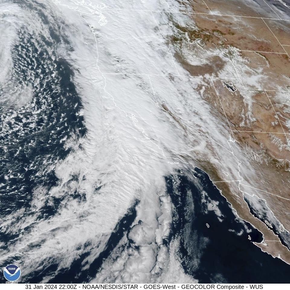 This GOES-West GeoColor composite satellite image provided by The National Hurricane Center and Central Pacific Hurricane Center/National Oceanic and Atmospheric Administration, shows a storm moving over California and the Western U.S. on Wednesday, Jan. 31, 2024. An atmospheric river is set to make its way into Northern California, bringing warnings of heavy rain, possible flooding and high winds. (NOAA via AP)