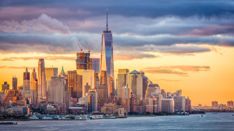 New York City financial district on the Hudson River at dawn.