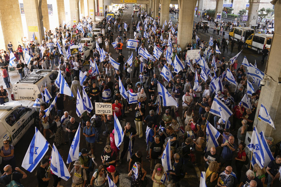Israelis protest against plans by Prime Minister Benjamin Netanyahu's government to overhaul the judicial system, at Ben Gurion Airport in Lod, near Tel Aviv, Israel, Monday, July 3, 2023. (AP Photo/Ohad Zwigenberg)