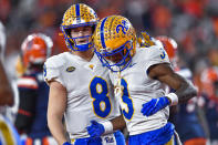 Pittsburgh wide receiver Jordan Addison, right, celebrates with quarterback Kenny Pickett after scoring a touchdown against Syracuse during the first half of an NCAA college football game in Syracuse, N.Y., Saturday, Nov. 27, 2021. (AP Photo/Adrian Kraus)