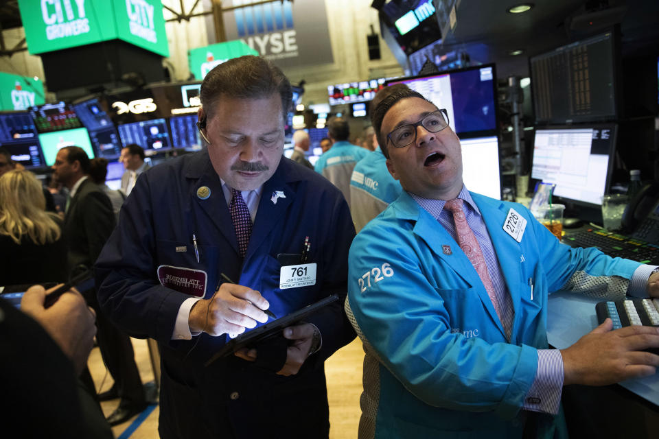 Stock traders John Santiago, left, and Paul Cosentino work at the New York Stock Exchange, Wednesday, Sept. 18, 2019. The Federal Reserve is expected to announce its benchmark interest rate later in the day. (AP Photo/Mark Lennihan)