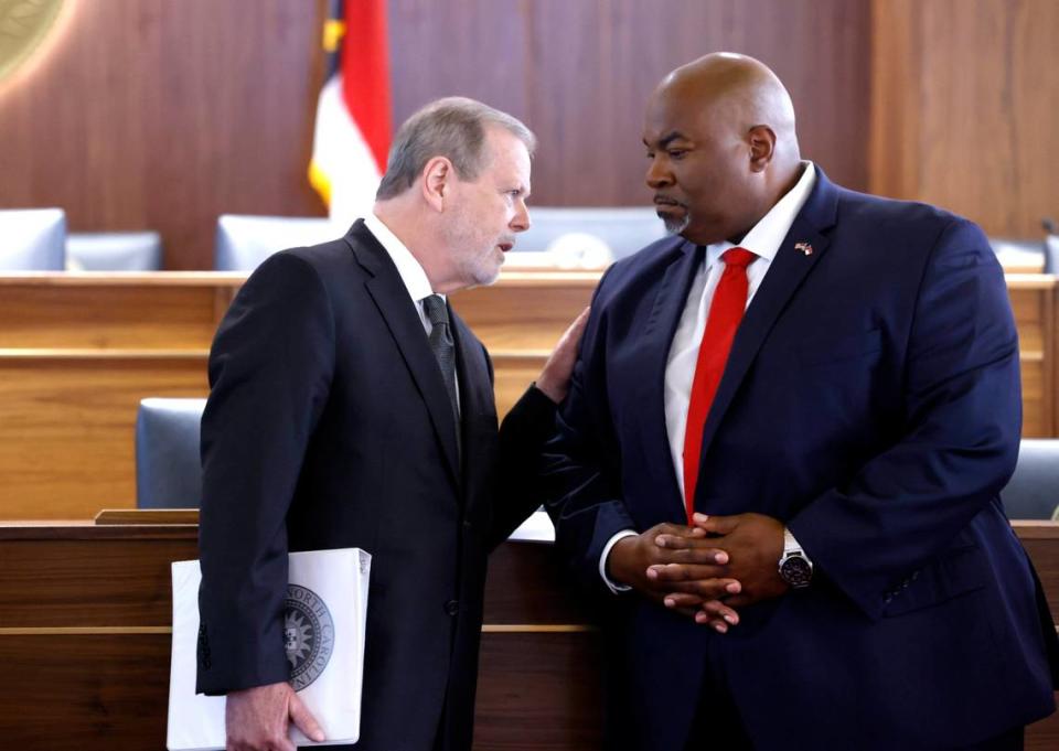 Senate Leader Phil Berger, left, talks with Lt. Gov. Mark Robinson during a press conference in Raleigh on Aug. 24, 2021.