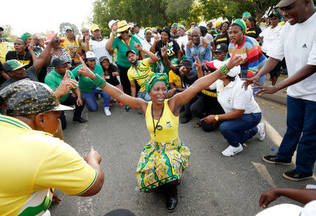 Supporters of presidential candidate Cyril Ramaphosa sing and dance at the gates of the Nasrec Expo Centre, where the 54th National Conference of the ruling African National Congress (ANC) is taking place, in Johannesburg, South Africa, December 17, 2017. REUTERS/Rogan Ward