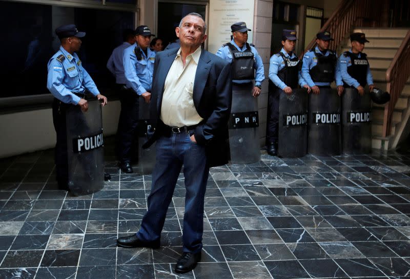 FILE PHOTO: Former Honduras' President Porfirio Lobo waits outside a court where his wife Rosa Elena Bonilla is appearing to face graft charges, in Tegucigalpa