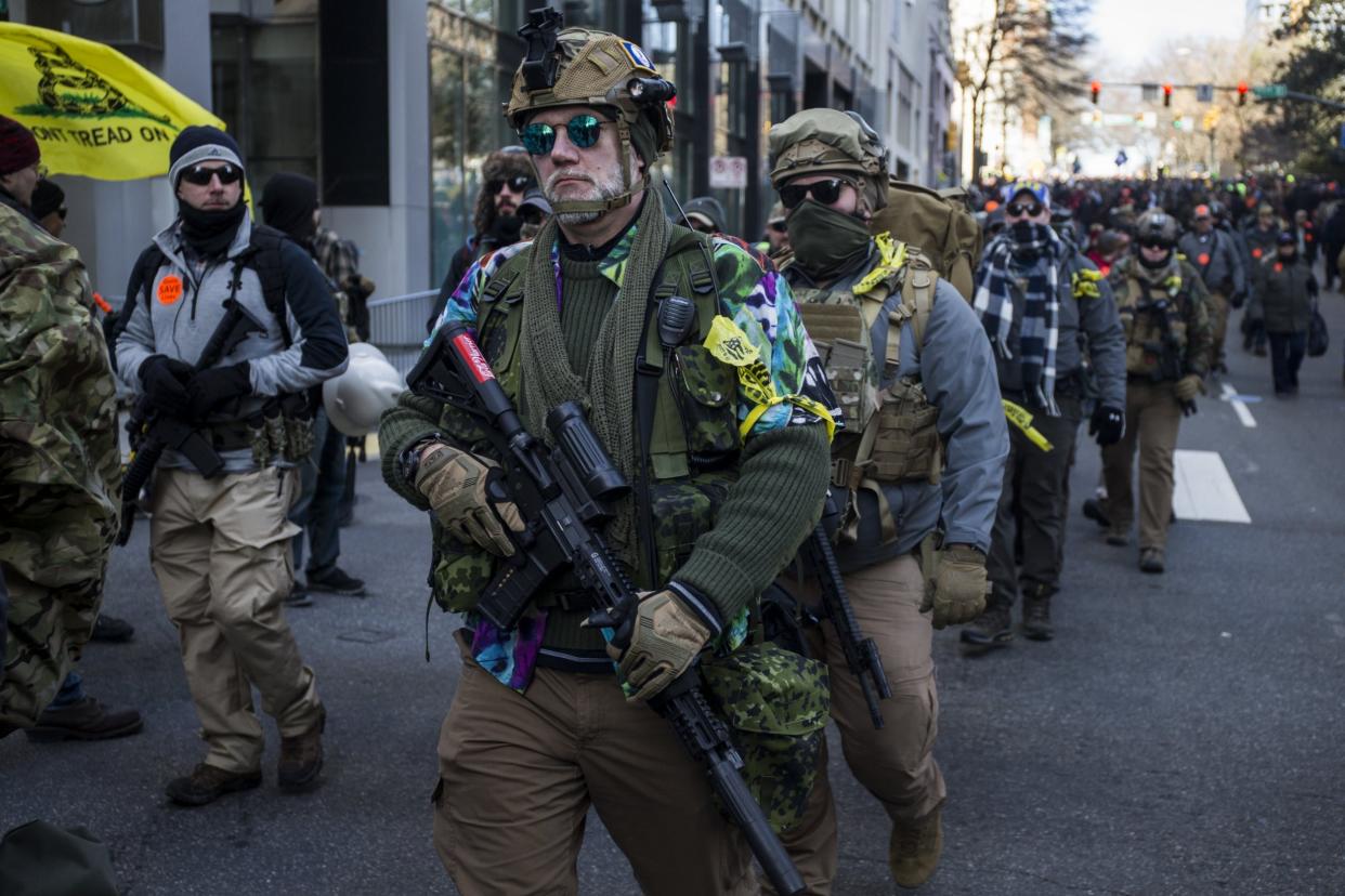 Gun rights advocates holding semi-automatic weapons attend a rally in Richmond, Virginia, yesterday: Getty