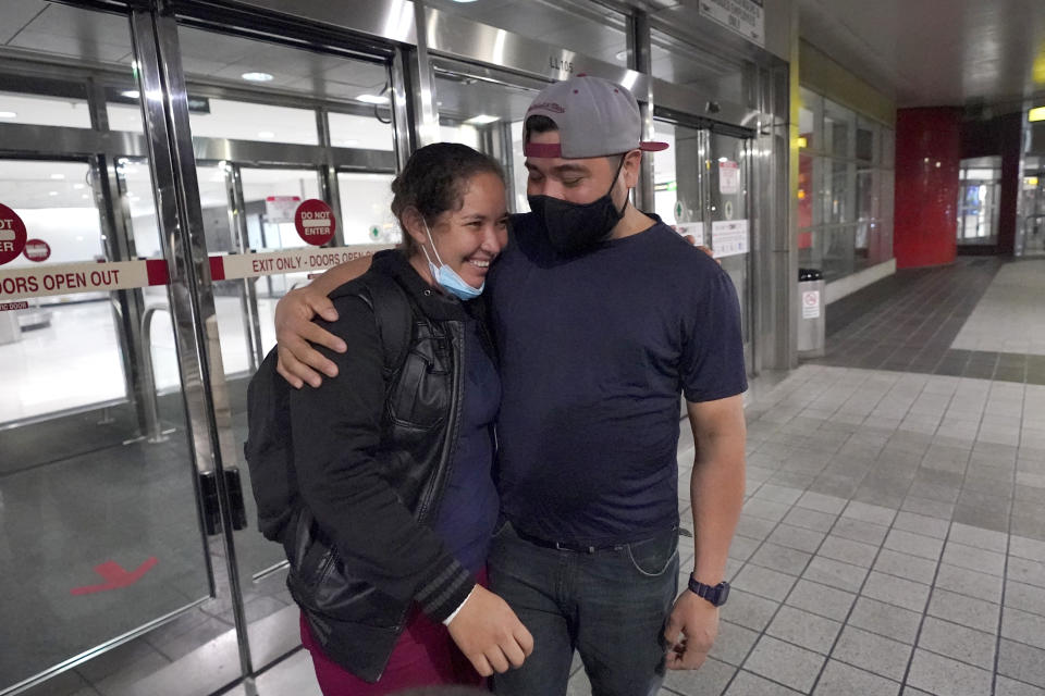 Celestina Ramirez, left, a migrant from Honduras, is hugged by her brother Marco Ramirez after they were reunited at Baltimore-Washington International Thurgood Marshall Airport, in Linthicum, Md., Wednesday, March 24, 2021. The siblings had not seen each other in 14 years. (AP Photo/Julio Cortez)