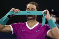 Rafael Nadal of Spain replaces his headband during his semifinal against Matteo Berrettini of Italy at the Australian Open tennis championships in Melbourne, Australia, Friday, Jan. 28, 2022. (AP Photo/Hamish Blair)