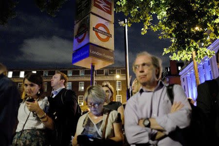 Commuters are seen outside Euston Station after police evacuated the area following a security alert in London, Britain, August 29, 2017. REUTERS/Tolga Akmen