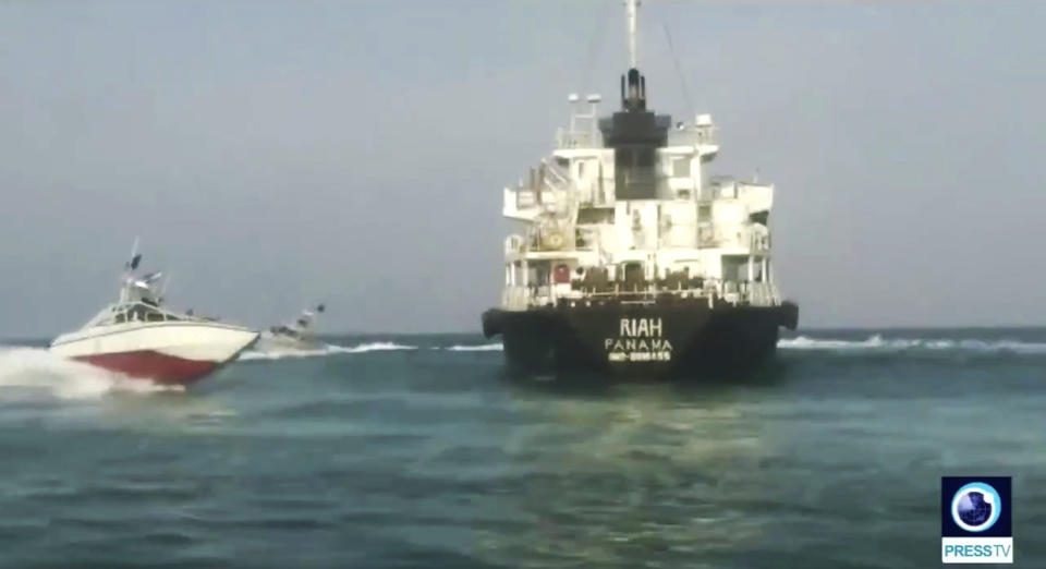 This undated photo provided by Iranian state television's English-language service, Press TV, shows the Panamanian-flagged oil tanker MT Riah surrounded by Iranian Revolutionary Guard vessels. Iran said Thursday, July 18, 2019, that its Revolutionary Guard seized a foreign oil tanker and its crew of 12 for smuggling fuel out of the country. The Riah, which had disappeared off trackers in Iranian territorial waters over the weekend, stopped transmitting its location early Sunday near Iran’s Qeshm Island, according to data listed on tracking site Maritime Traffic. (Press TV via AP)