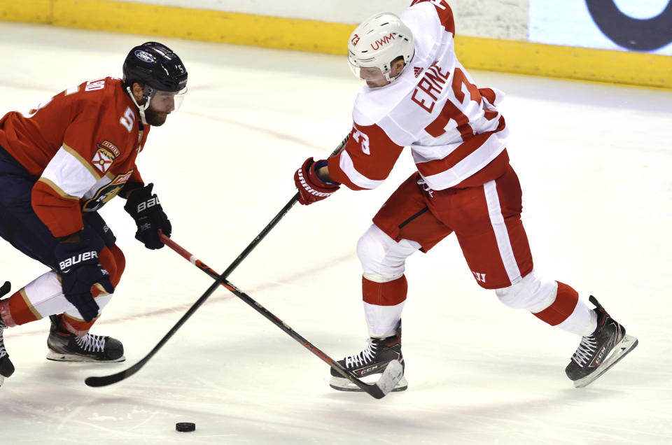 Detroit Red Wings left wing Adam Erne (73) loses the puck as Florida Panthers defenseman Aaron Ekblad (5) defends on the play during the second period of an NHL hockey game Tuesday, Feb. 9, 2021, in Sunrise, Fla. (AP Photo/Jim Rassol)