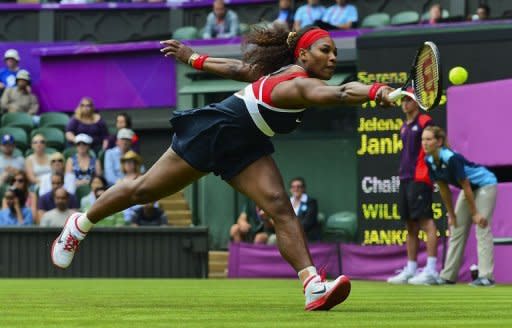 Serena Williams of the US returns to Serbia's Jelena Jankovic during their women's singles tennis match at the London 2012 Olympic Games at the All England Tennis Club in Wimbledon, southwest London. Serena won 6-3, 6-1