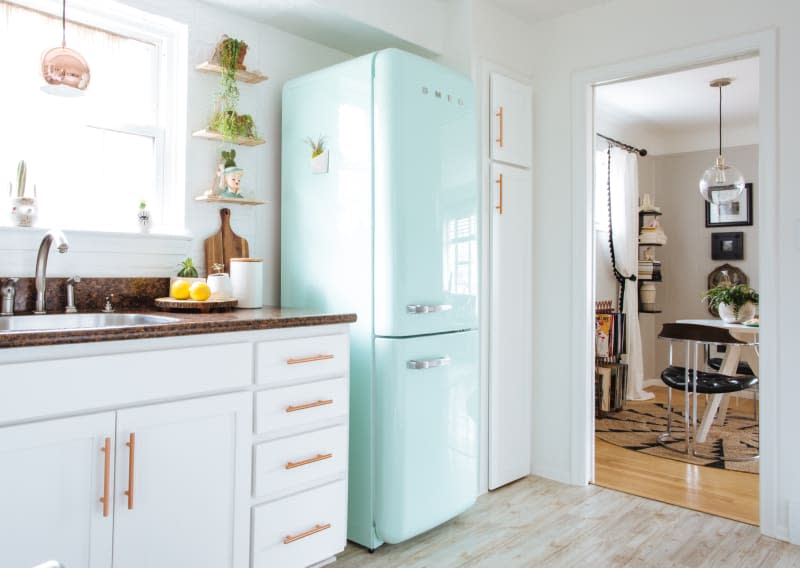 A small kitchen with a bright blue SMEG fridge