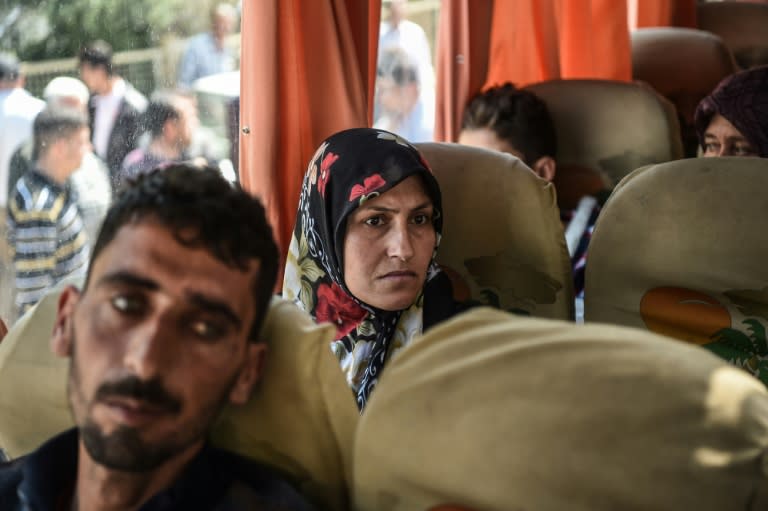 Syrian victims of a suspected chemical attack are carried in a bus back to the Syrian border after treatment in Turkey on April 7, 2017