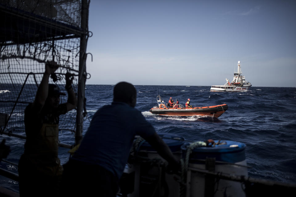 In this photo taken on Saturday, Nov. 24, 2018 photo, the Spanish NGO Proactiva Open Arms RIB vessel approaches Nuestra Madre de Loreto, a Spanish fishing vessel that rescued twelve migrants two days ago about 78 miles north off Libyan shore. The Open Arms assisted migrants medically and provided them with food, blankets and clothes. (AP Photo/Javier Fergo)