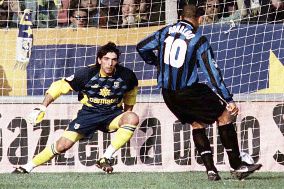 FILE - Parma's goalie Gianluigi Buffon prepares to block a penalty kicked by Inter's Ronaldo of Brazil during their Italian League soccer match Parma vs Inter in Parma, on March 8, 1998. At age 45 and after a career that included a World Cup title with Italy, a long list of trophies with Juventus and many years when he was considered among the best goalkeepers in soccer, Gianluigi Buffon announced his retirement on Wednesday, Aug. 2, 2023. (AP Photo/Claudio Miano)