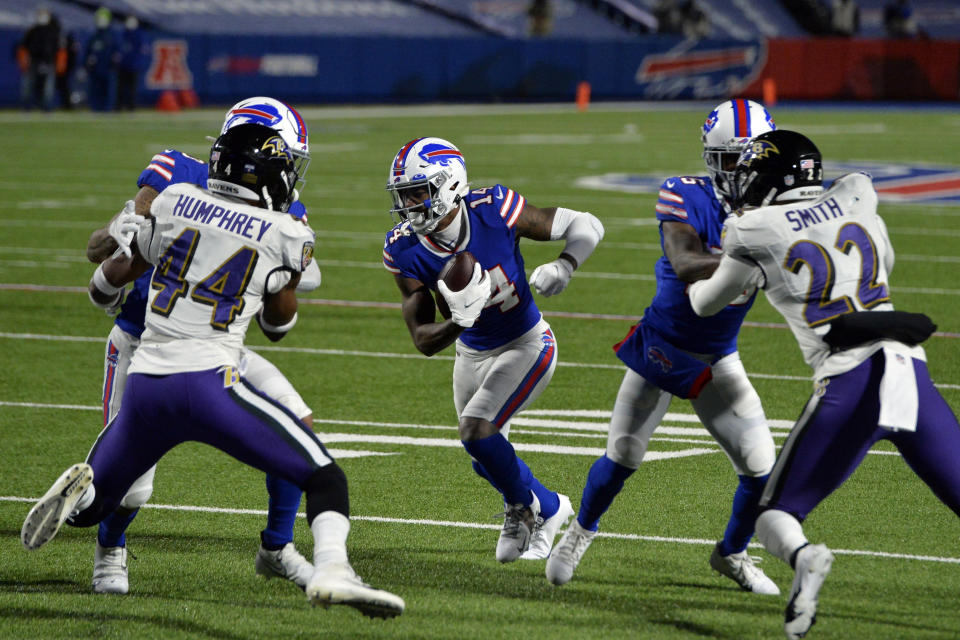 Buffalo Bills wide receiver Stefon Diggs (14) runs past Baltimore Ravens' Marlon Humphrey (44) and Jimmy Smith (22) for a touchdown during the second half of an NFL divisional round football game Saturday, Jan. 16, 2021, in Orchard Park, N.Y. (AP Photo/Adrian Kraus)