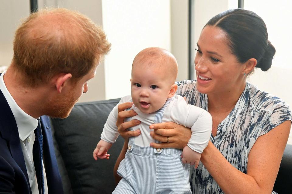 Prince Harry and his wife Meghan, Duchess of Sussex, holding their son Archie (PA)