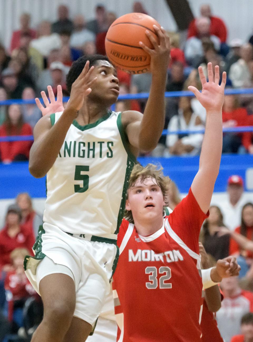 Richwoods' Jared Jackson (5) goes to the basket against Morton's Wes Gudeman in the first half of their Class 3A regional basketball game Friday, Feb. 23, 2024 at Limestone High School in Bartonville.