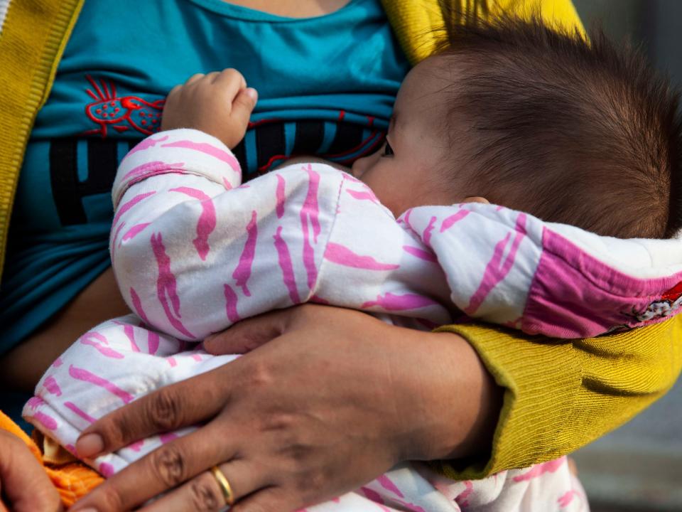 A woman breastfeeding her baby