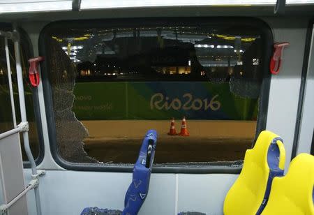A broken window on an official media bus after it shattered when driving accredited journalists to the Main Transport Mall from the Deodoro venue of the Rio 2016 Olympic Games in Rio de Janeiro, August 9, 2016. REUTERS/Shannon Stapleton