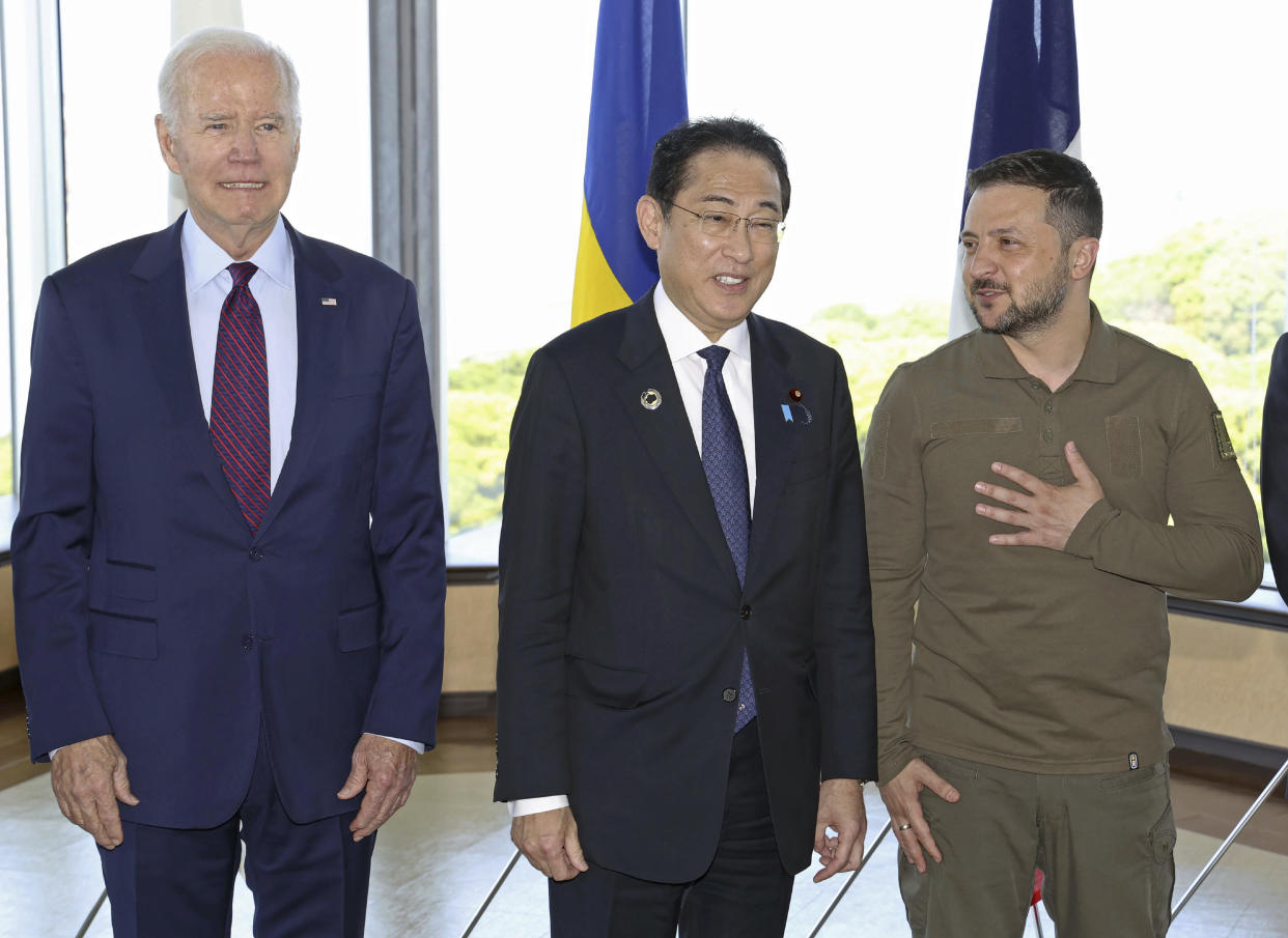 Ukrainian President Volodymyr Zelenskyy, right, Japan's Prime Minister Fumio Kishida, center, and U.S. President Joe Biden, pose for a photo with other G7 leaders before a working session on Ukraine during the G7 Summit in Hiroshima, western Japan, Sunday, May 21, 2023. (Kyodo News via AP)