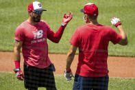 Washington Nationals' Adam Eaton (2), left, speaks with a staff member as the Washington Nationals hold their first training camp work out at Nationals Stadium, Friday, July 3, 2020, in Washington. (AP Photo/Andrew Harnik)