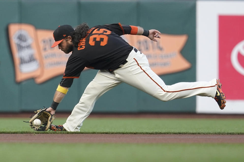 San Francisco Giants shortstop Brandon Crawford fields a grounder by Atlanta Braves' Jorge Soler, who was out at first during the first inning of a baseball game in San Francisco, Saturday, Sept. 18, 2021. (AP Photo/Jeff Chiu)