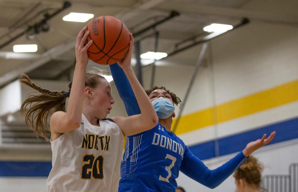 Donovan's Gabriella Ross tries to steal a rebound from North's Megan Sias. Donovan Catholic Girls Basketball vs Toms River North in Toms River, NJ on February 23, 2021.