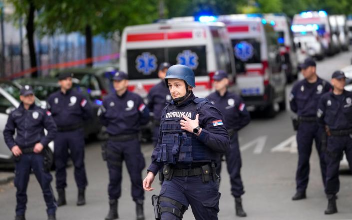 Large numbers of police - Darko Vojinovic/AP Photo